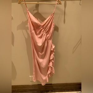 Pink strappy midi dress with side ruffle and slit.